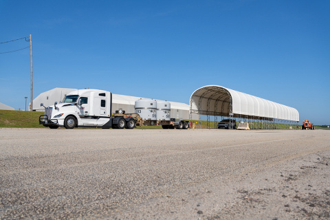 A large white truck with two white tanks on the back 