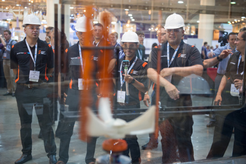 A team stares at their wind turbine in the wind tunnel