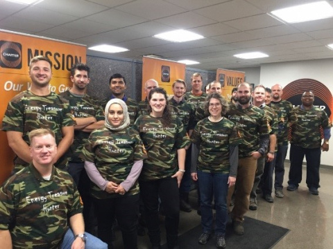 a photo of more than a dozen men and women with camouflage shirts.