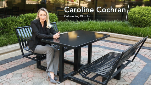 Caroline Cochran sits at a table and talks about nuclear energy.