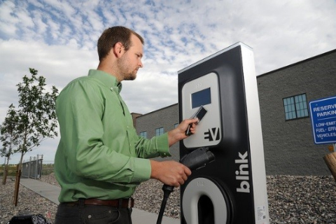 Picture of a man paying for EV charging