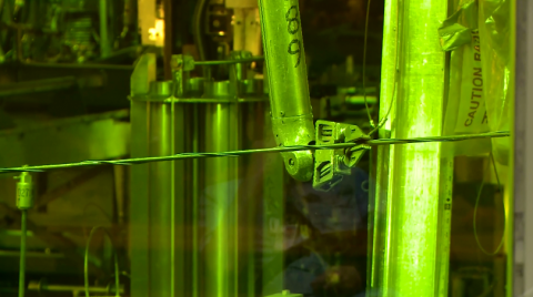 A photo of a mechanical claw inside a hot cell