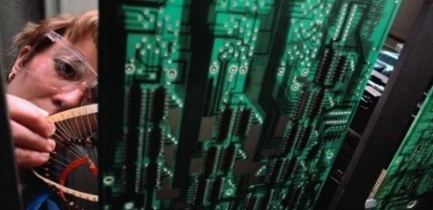 Picture of a researcher looking at a chip