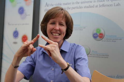 Brita Hampton, camp coordinator, shows the ASL sign for "camp."