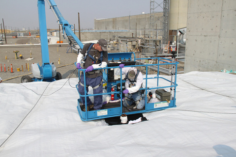 Workers insert probes through existing risers on top of PUREX Tunnel 1 to check conditions inside of the collapsed tunnel. Visual and radiological conditions inside the tunnel will support grout placement.