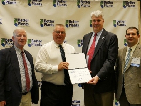 a photo of 4 men, including AMO director Mark Johnson presenting an award.