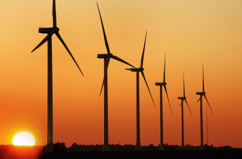 Wind turbines against a red sky