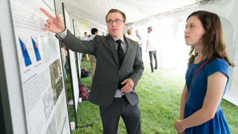 Summer intern William Trevillyan explaind his nanoparticle research with fellow intern Savannah Mitchem.