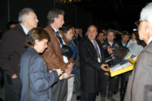 People in business attire standing in a convention hall lobby.