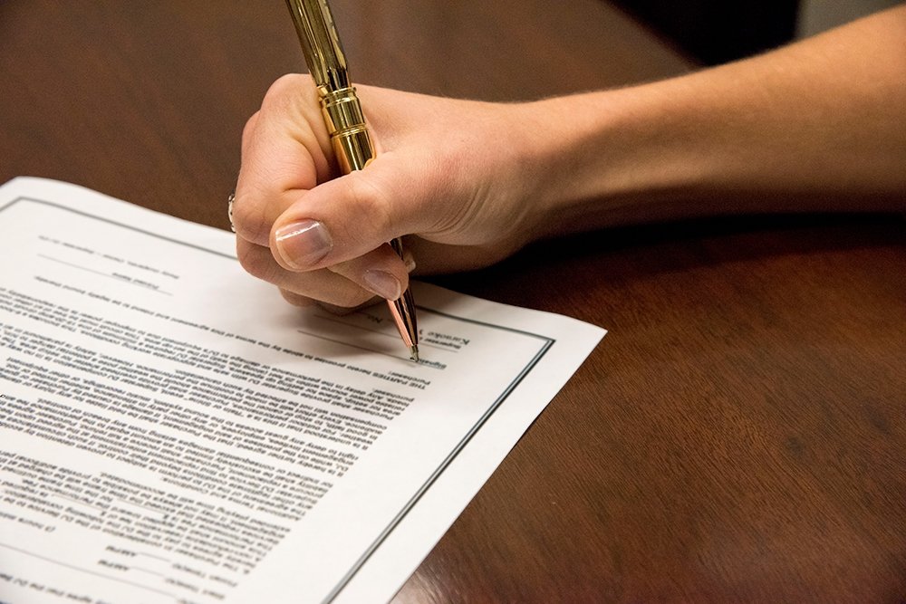 Woman signs a contract