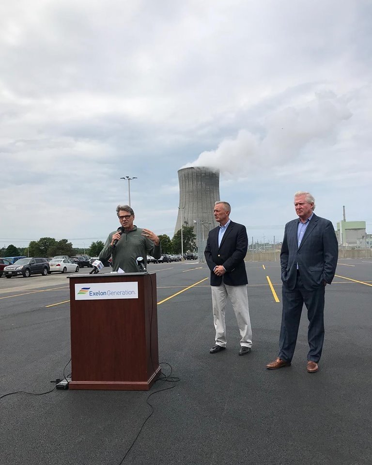 Secretary Perry talks in front of a nuclear power plant.