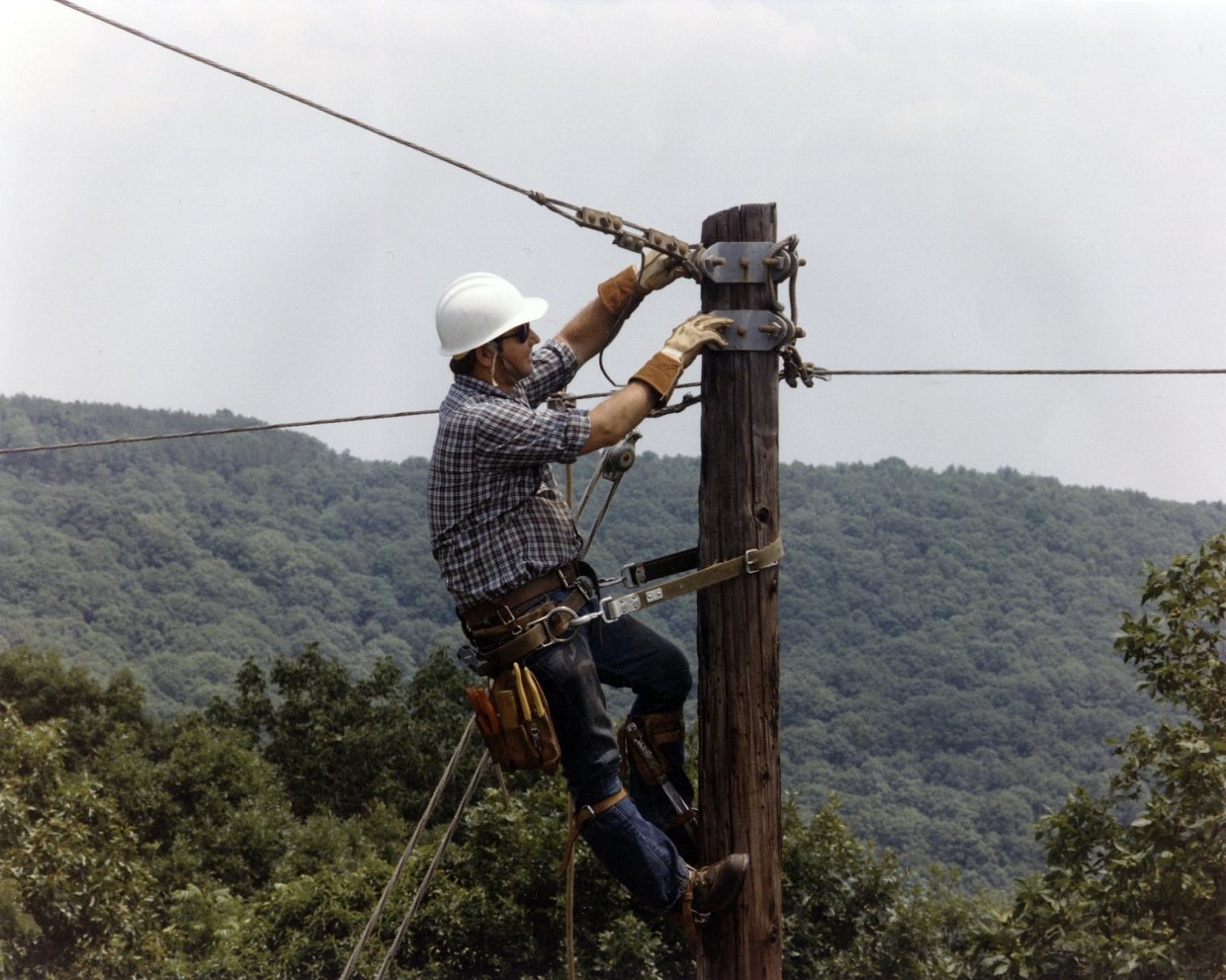 Image of a lineman working on a powerline