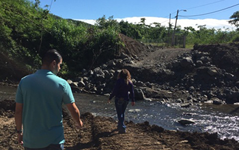 Two people walking near stream in Puerto Rico
