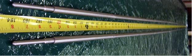 A photo of a nuclear test rod with measuring tape by it