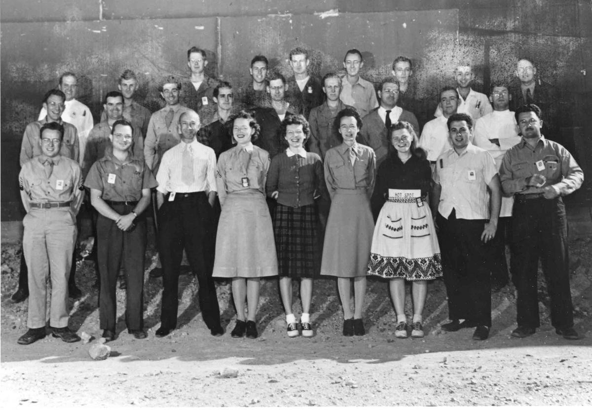 men and women stand in rows