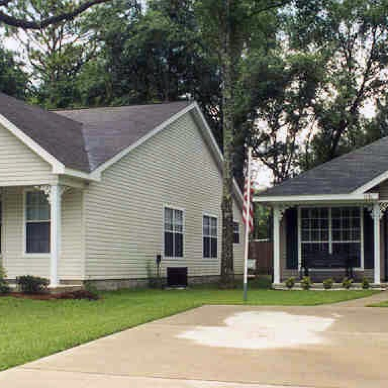 Photo of a house and garage with a driveway leading up to them.