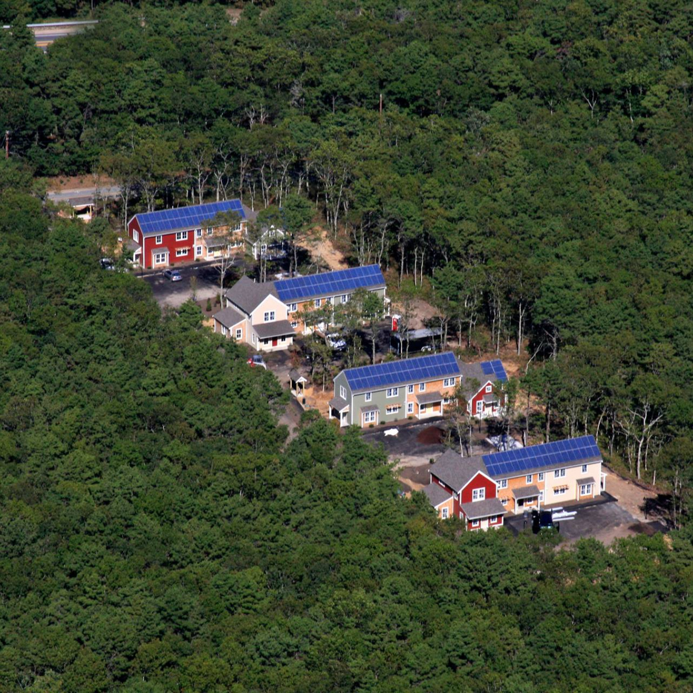 aerial shots of homes with solar panels on their roof.