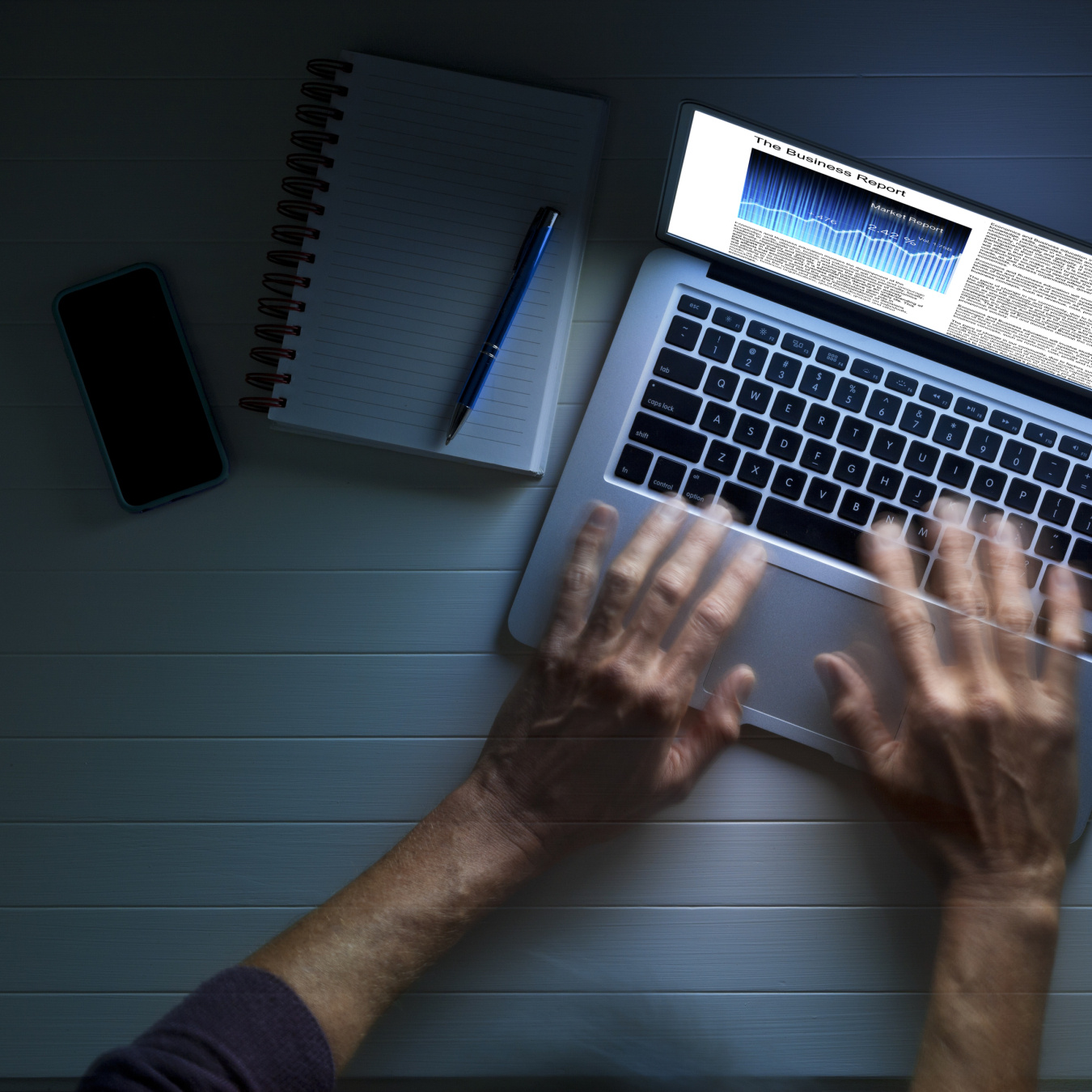 hands typing on a laptop keyboard