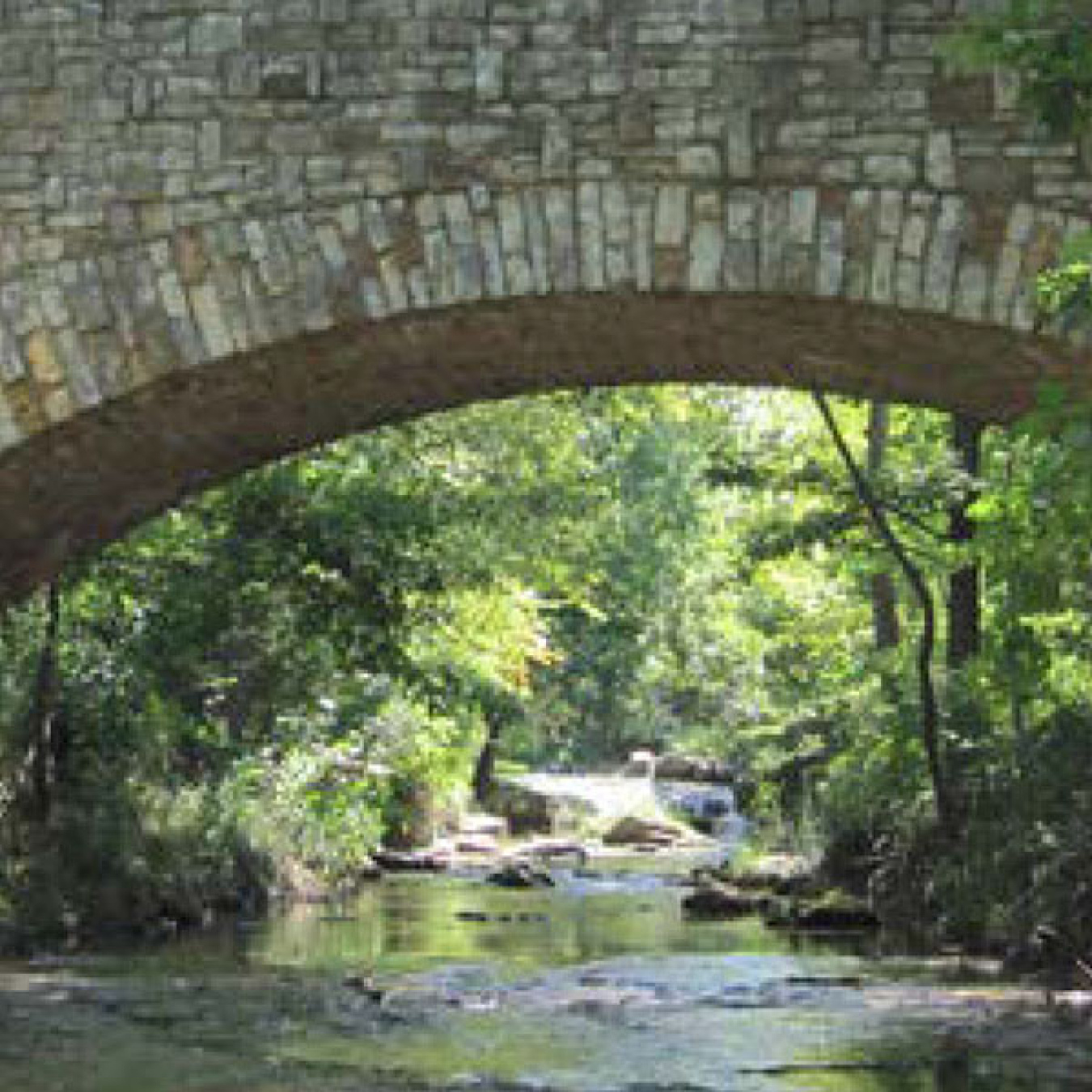 A stone bridge over a creek.