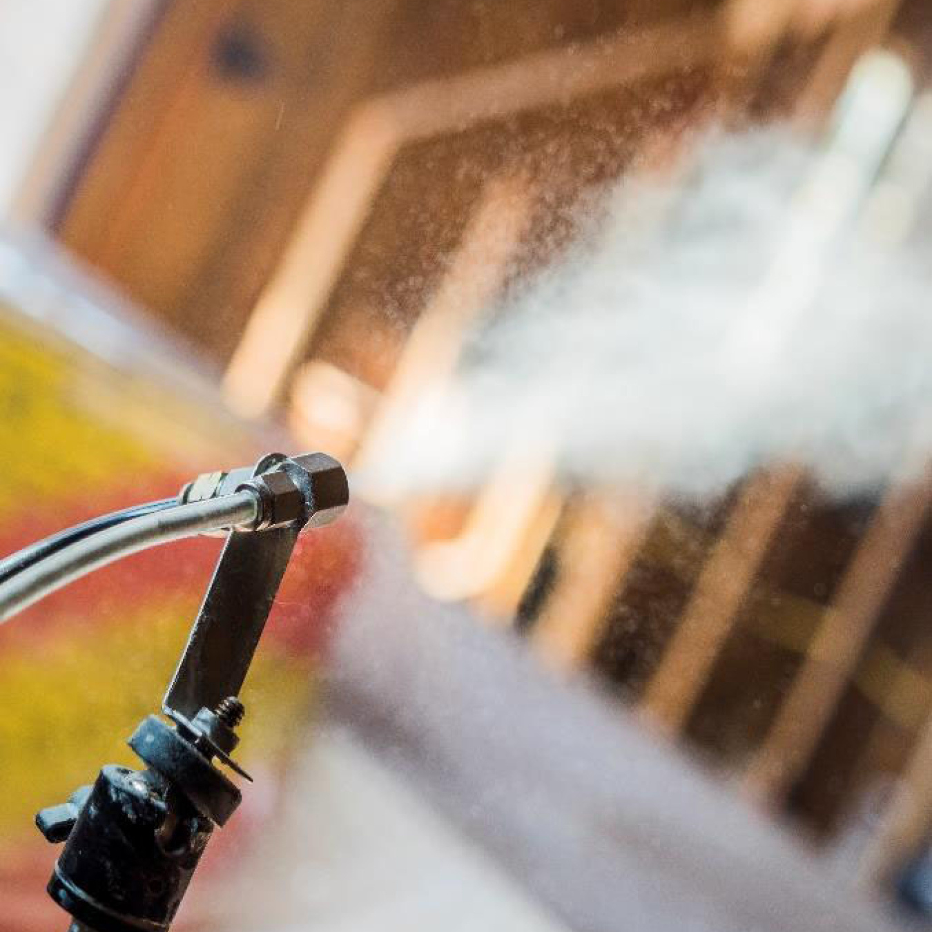 Photo of a hose spraying on a home.