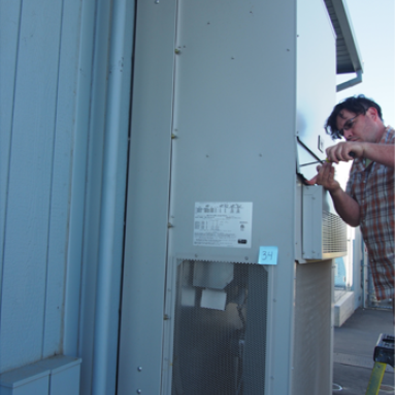 A man working on an HVAC unit.