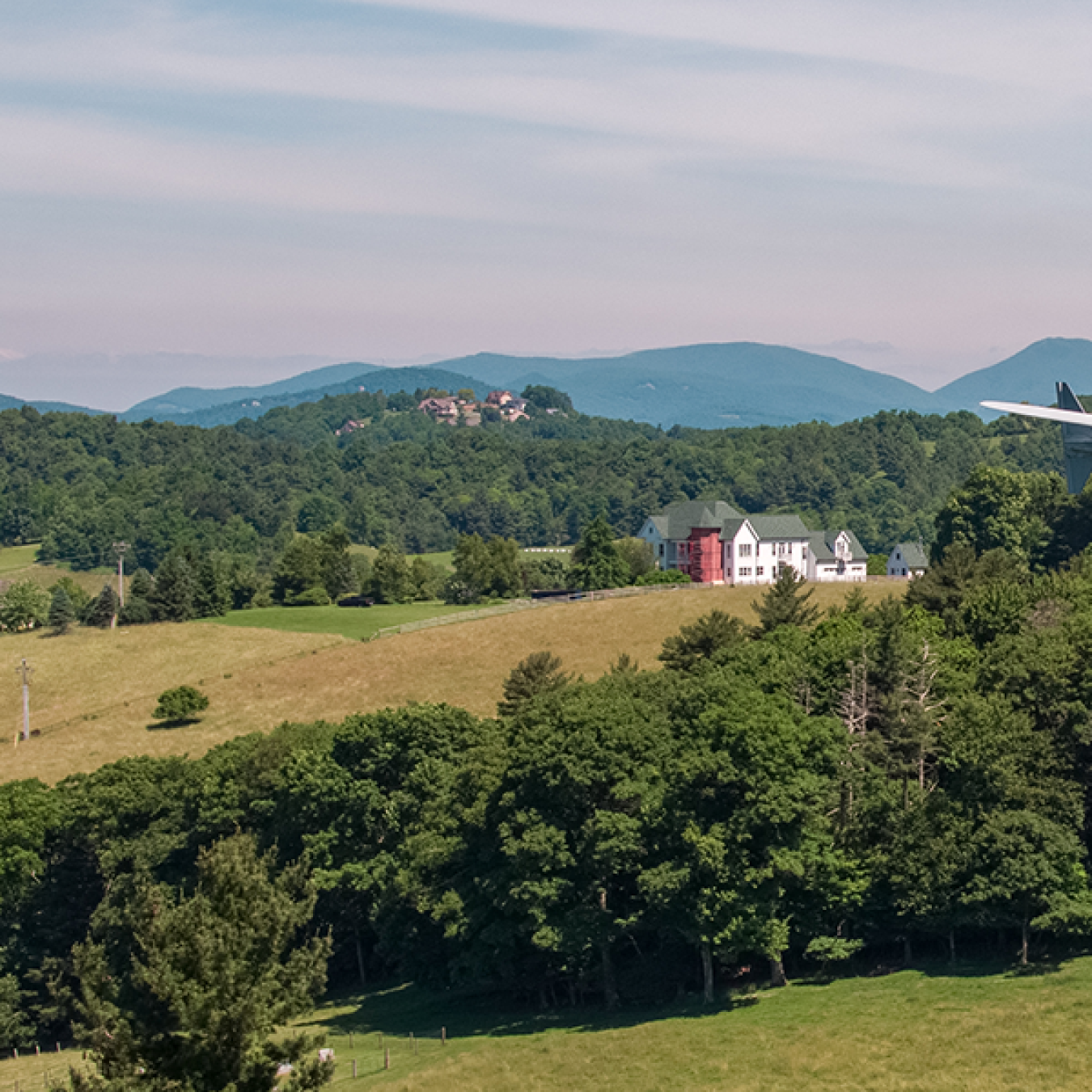 Distributed wind turbine with mountains in the background.