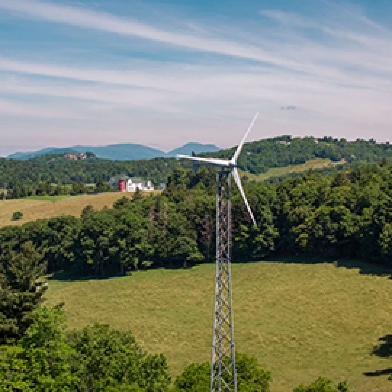 Distributed wind turbine with mountains in the background.