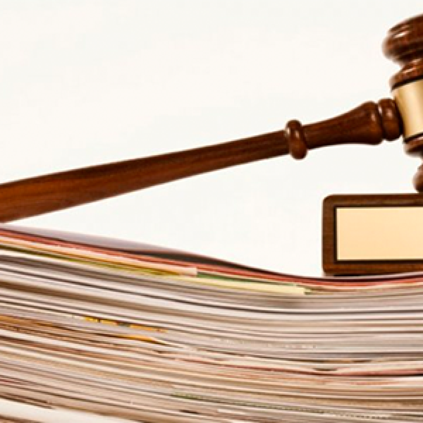 A gavel on top of a stack of papers.