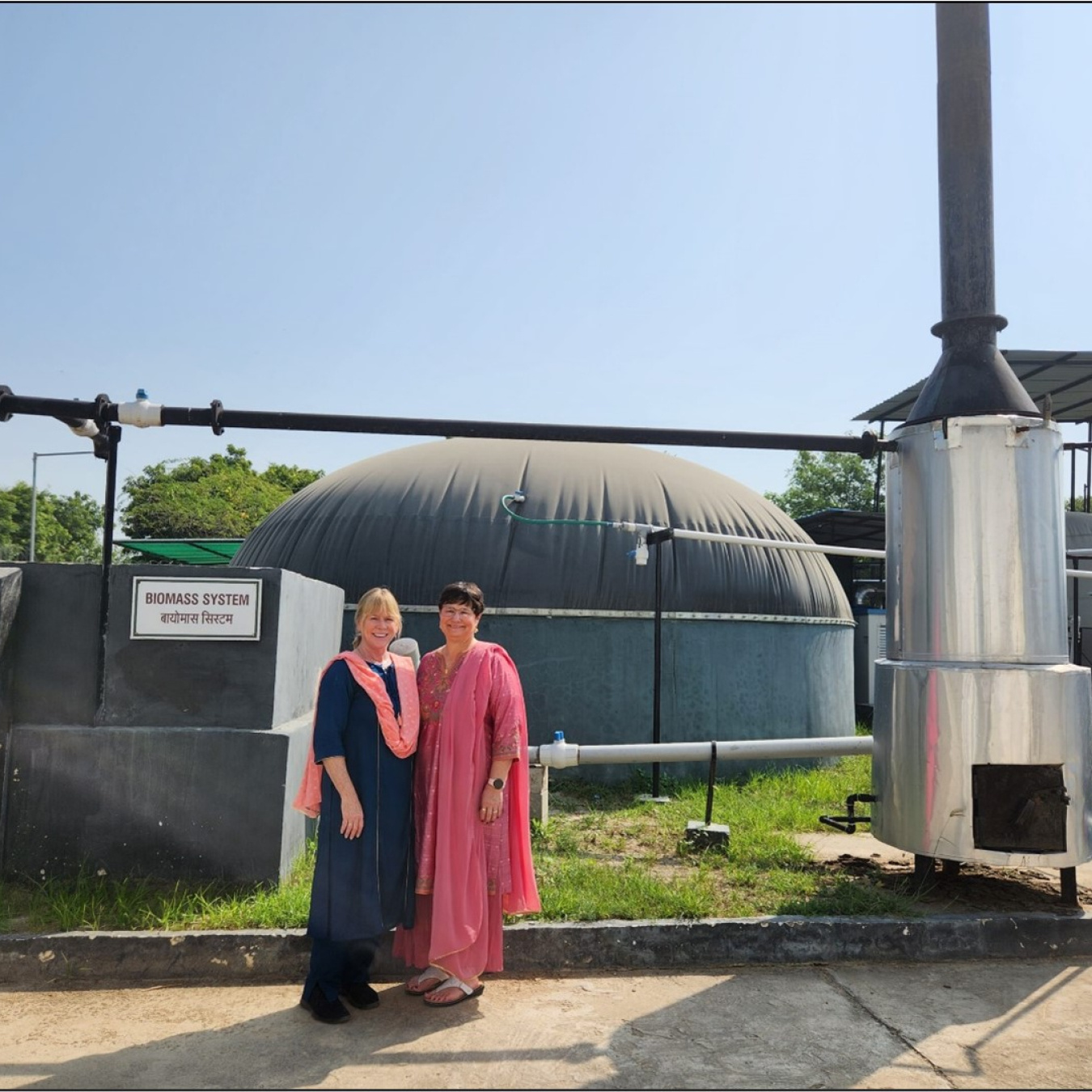 Merrill Smith (left) and Noel Schulz at the Harnoo Village Biomass System. 
