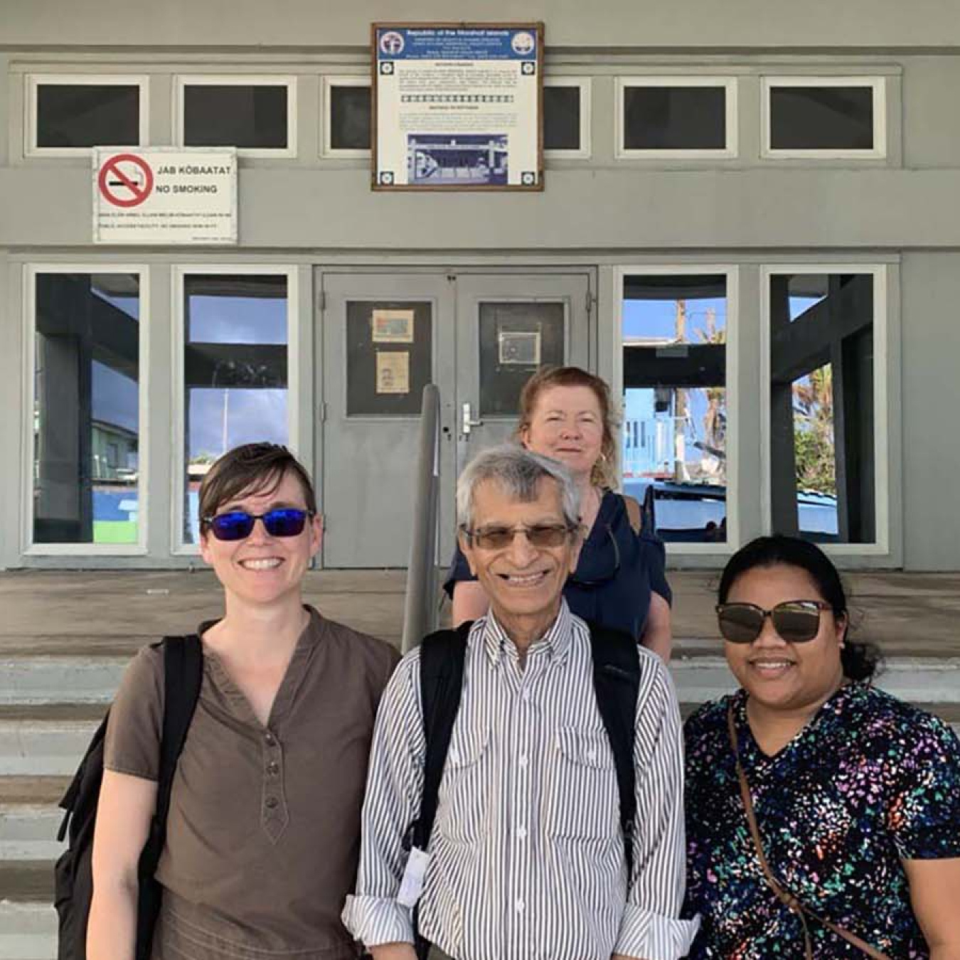 Dr. Ashok Vaswani (middle front) with Nurse Vanissa Toka, Dr. S. Robin Elgart, and Michelle Yamaguchi outside Ebeye Hospital 