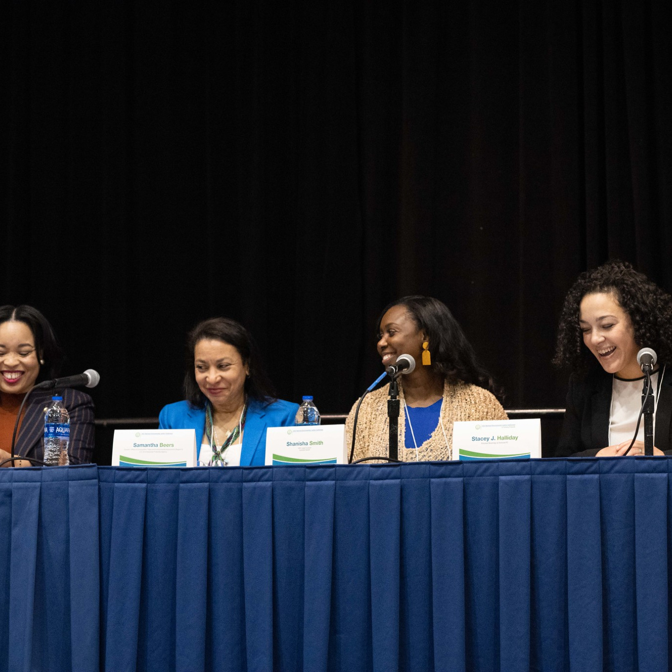Four women speaking on a panel