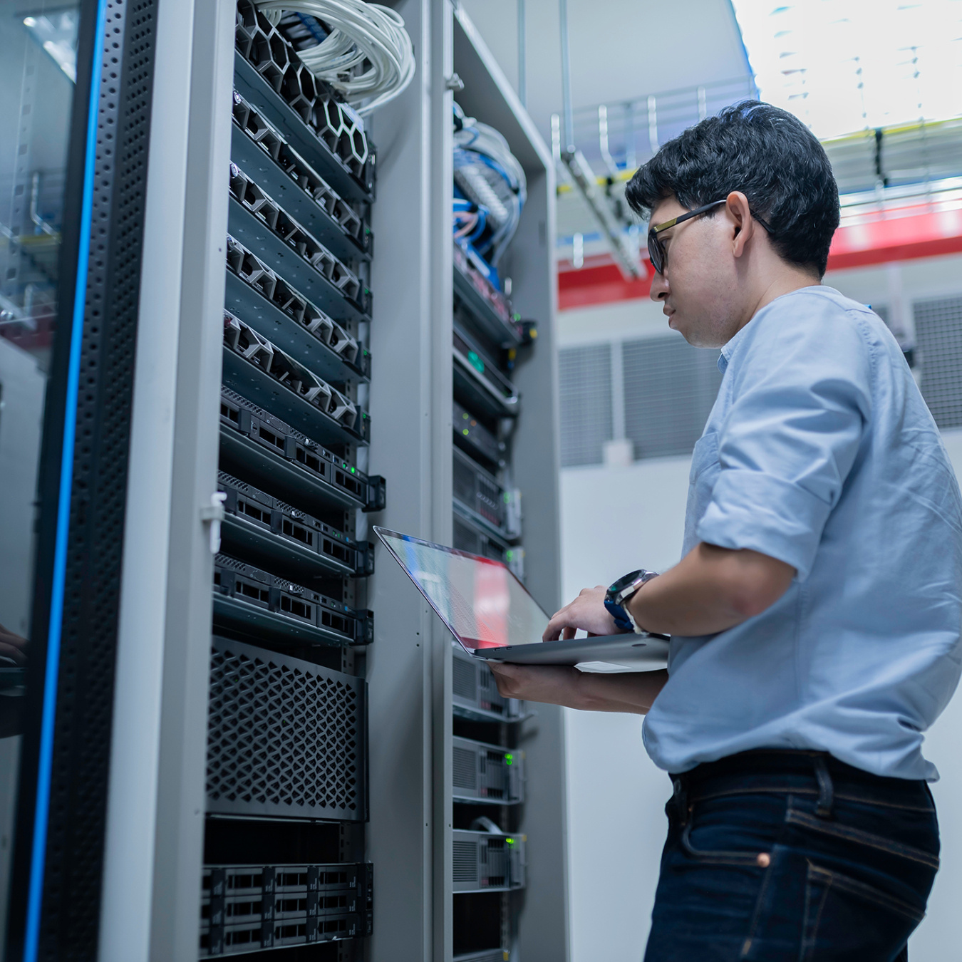 Person standing in front of server racks