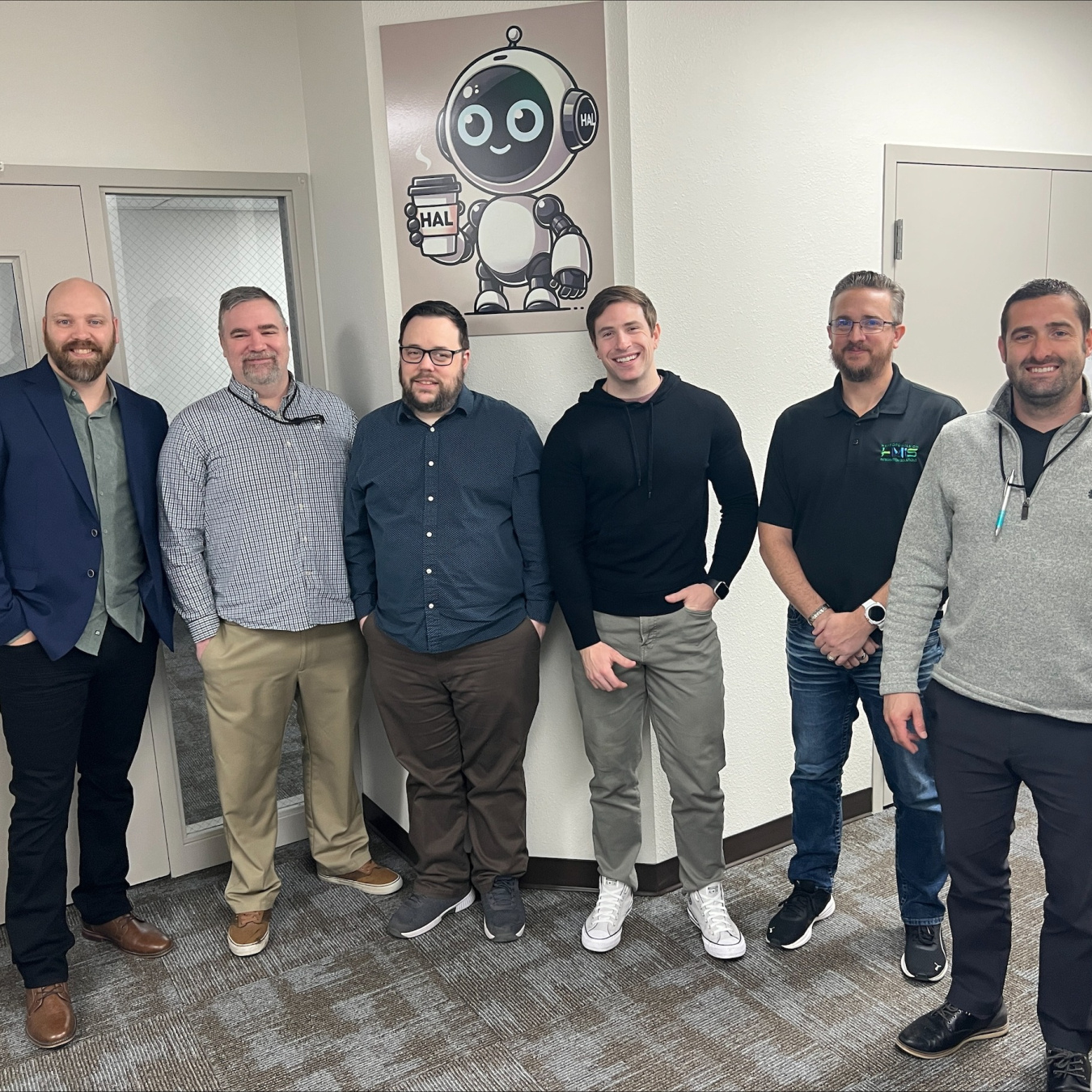 A group of employees smiling for a group photo