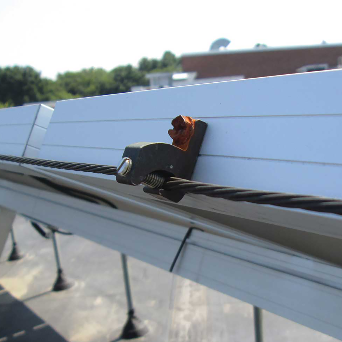 A corroded ground screen in a steel solar PV frame