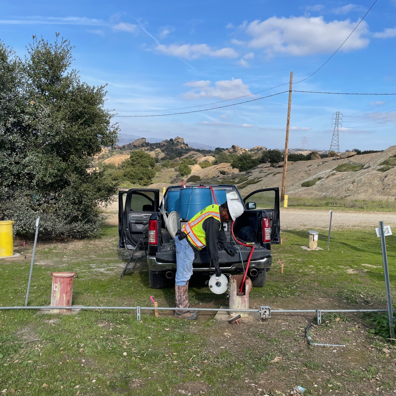 Man near truck measures water levels