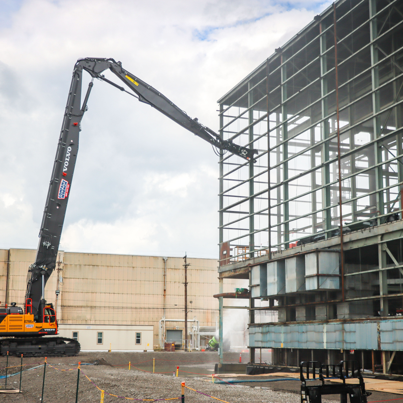 A building being worked on by a construction vehicle