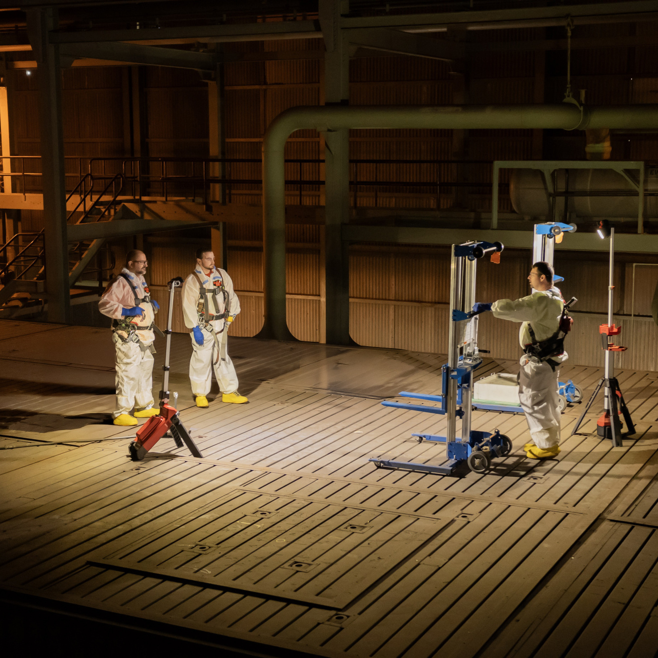 Employees in protective gear using scan technology at the Oak Ridge Site