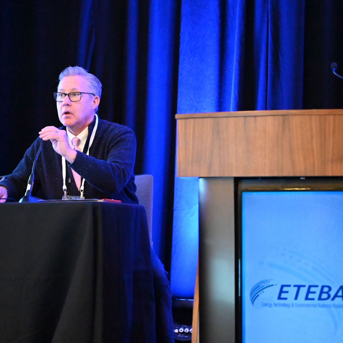The PPPO and Oak Ridge field manager Erik Olds sitting at a panel table on a stage