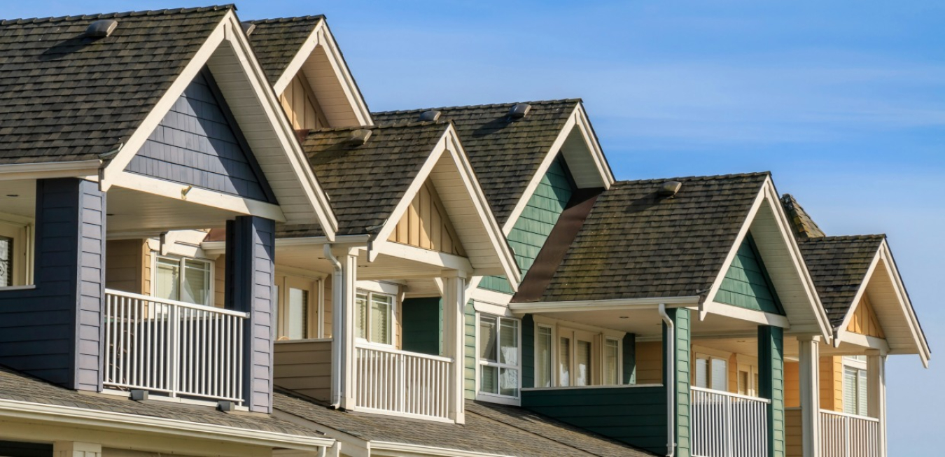 A row of upper level attached homes with balconies.