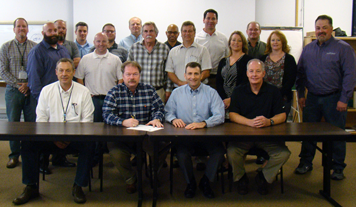 Officials from Portsmouth/Paducah Project Office and Portsmouth Mission Alliance gather to sign the partnering agreement.