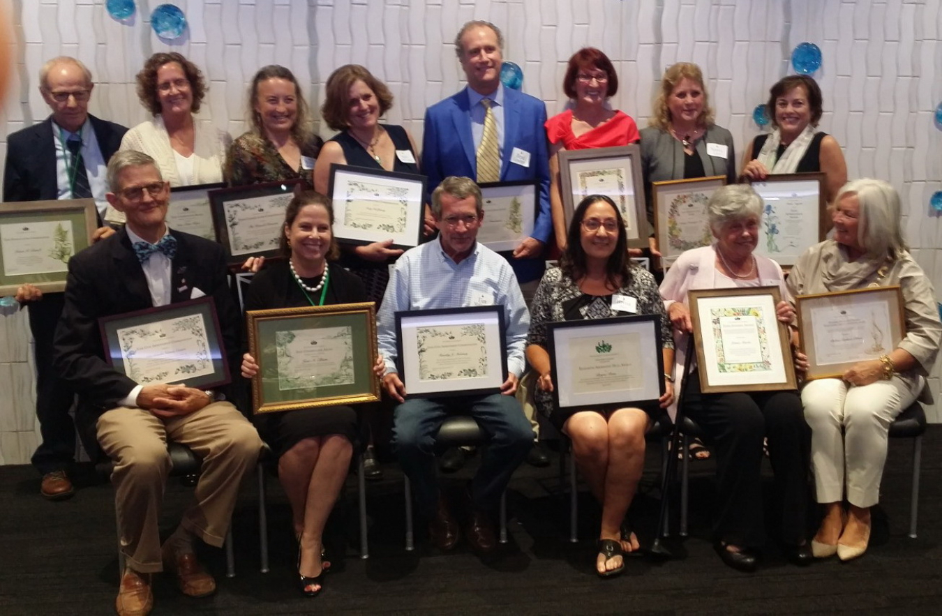 A Fernald Preserve representative (top, third from left) accepts the GCA commendation, along with other GCA Zone 10 recipients.