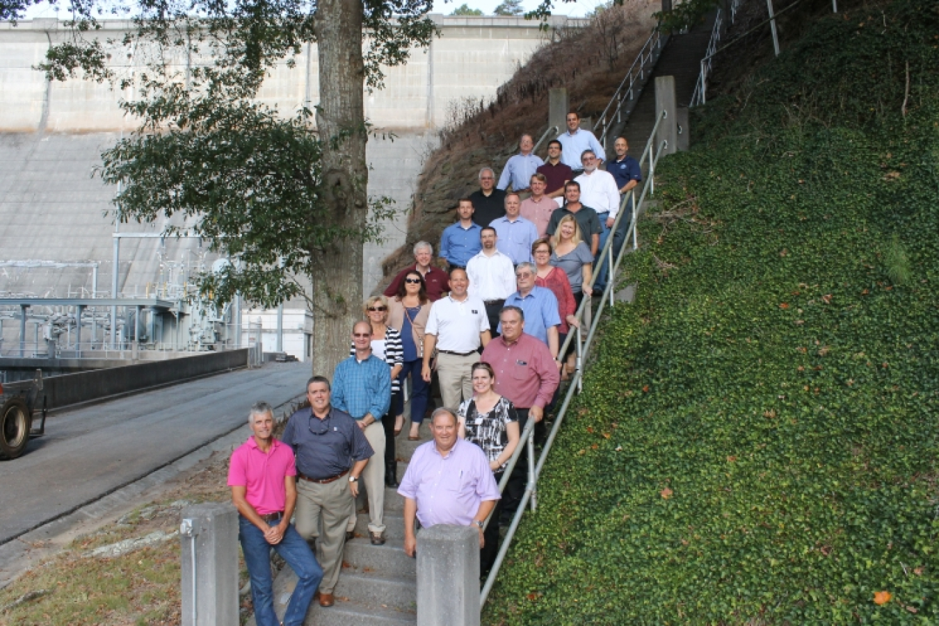 Alliance members standing on the stairs leading up to the Lake Allatoona Dam