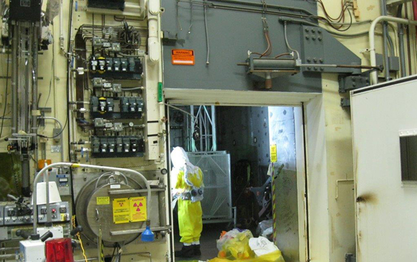 Workers stage waste in bags for removal from the 324 Building airlock door.