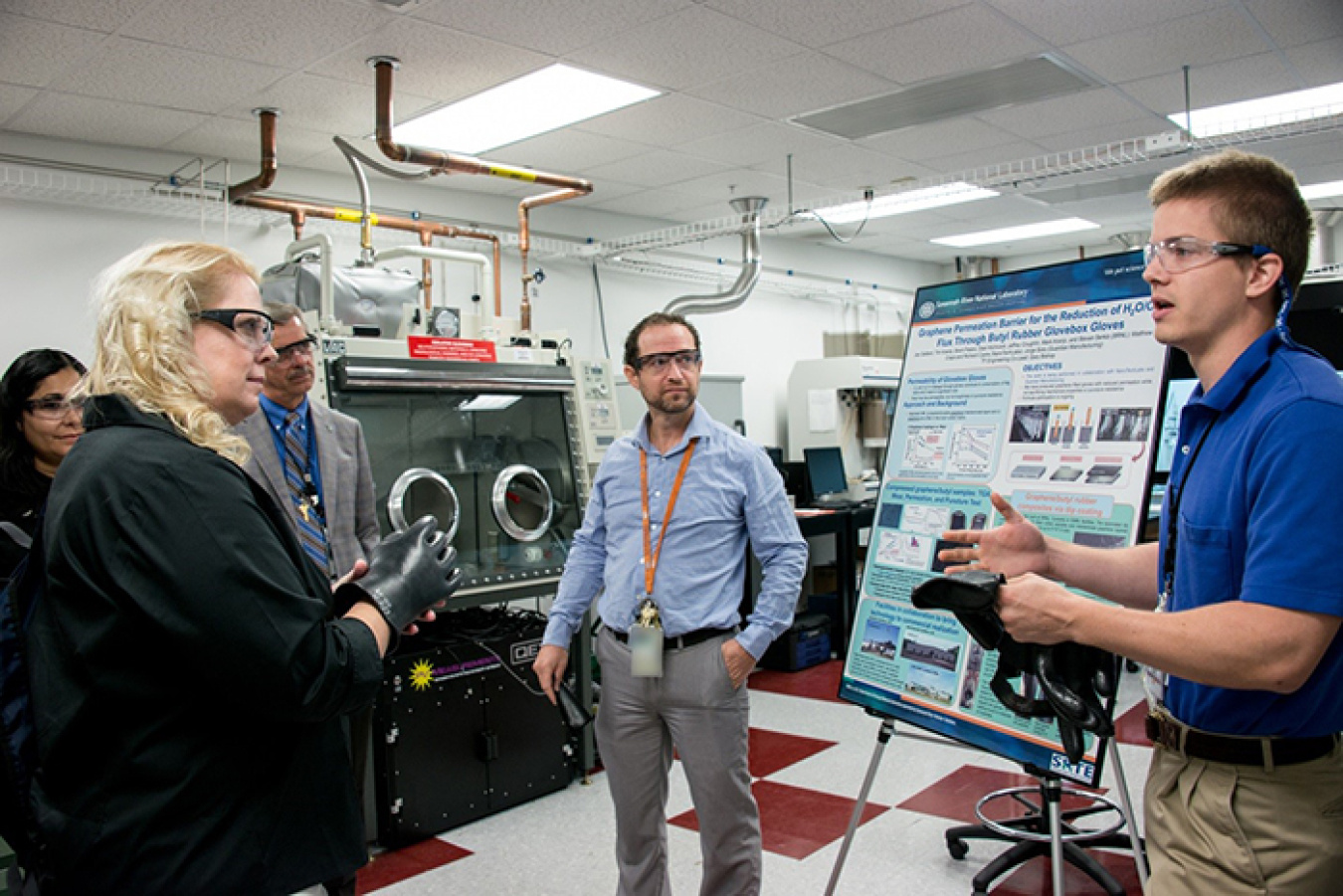 Charboneau takes part in a demonstration on glovebox gloves.