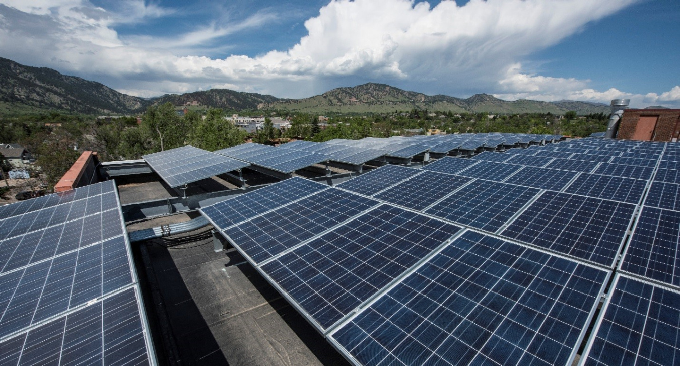 Solar panel array with mountains in the background