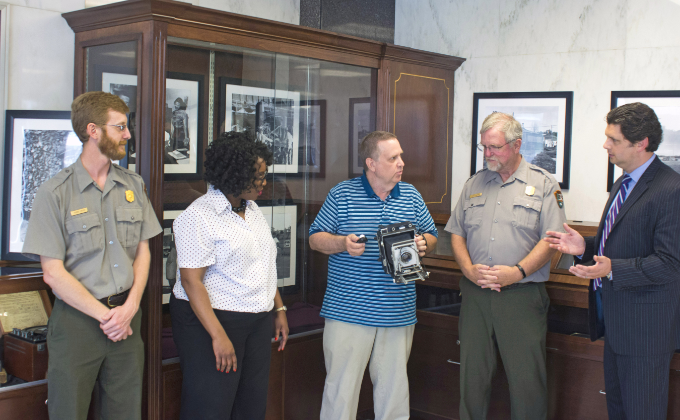 DOE and NPS staff discuss the Oak Ridge, Tennessee, photography exhibit.