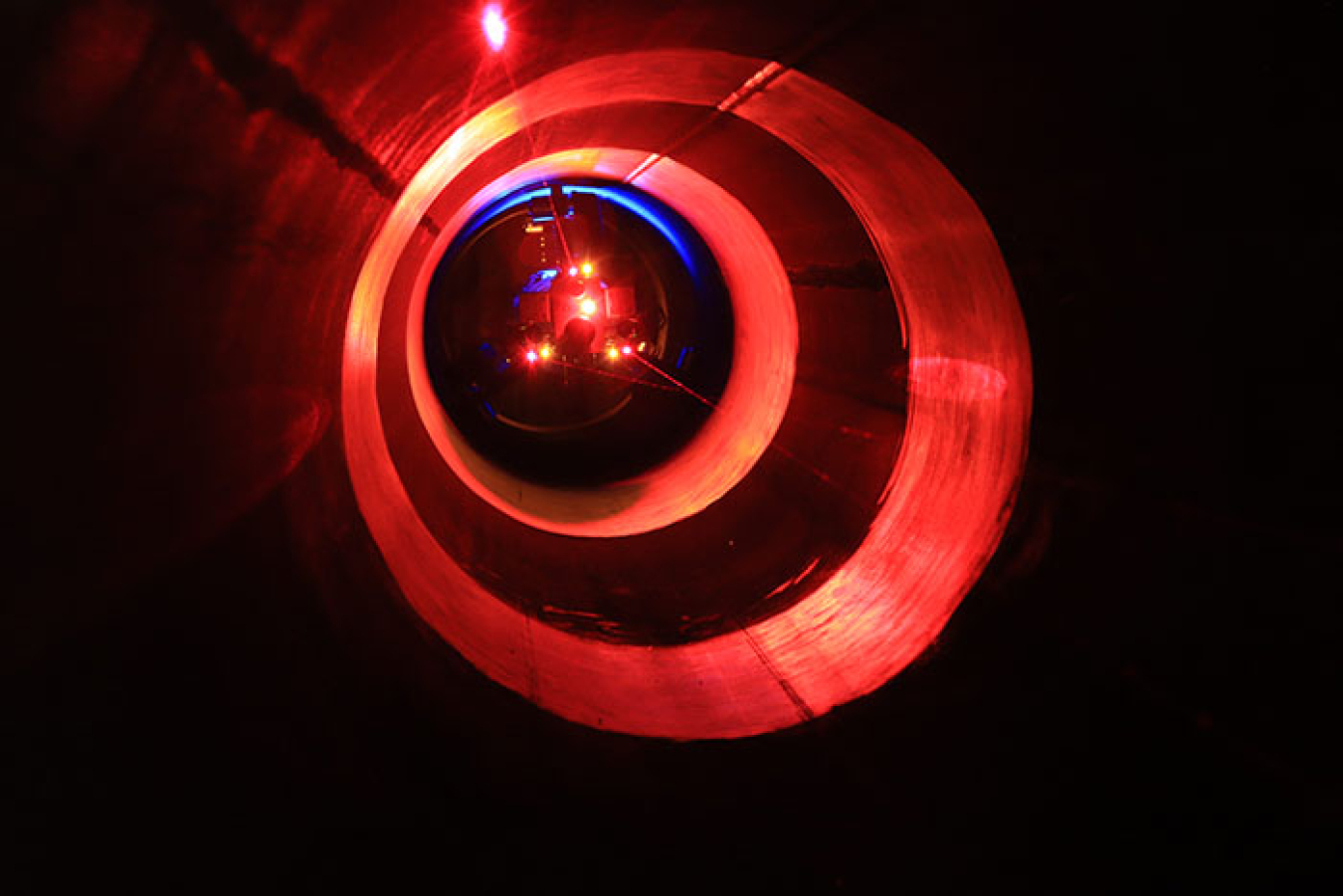 PipeDream measures the volume of surrogate deposits while spiraling sensors through a test pipe. Its headlights alternate white and ultraviolet to acquire the visual and fluorescent appearance of the surrogate deposits.