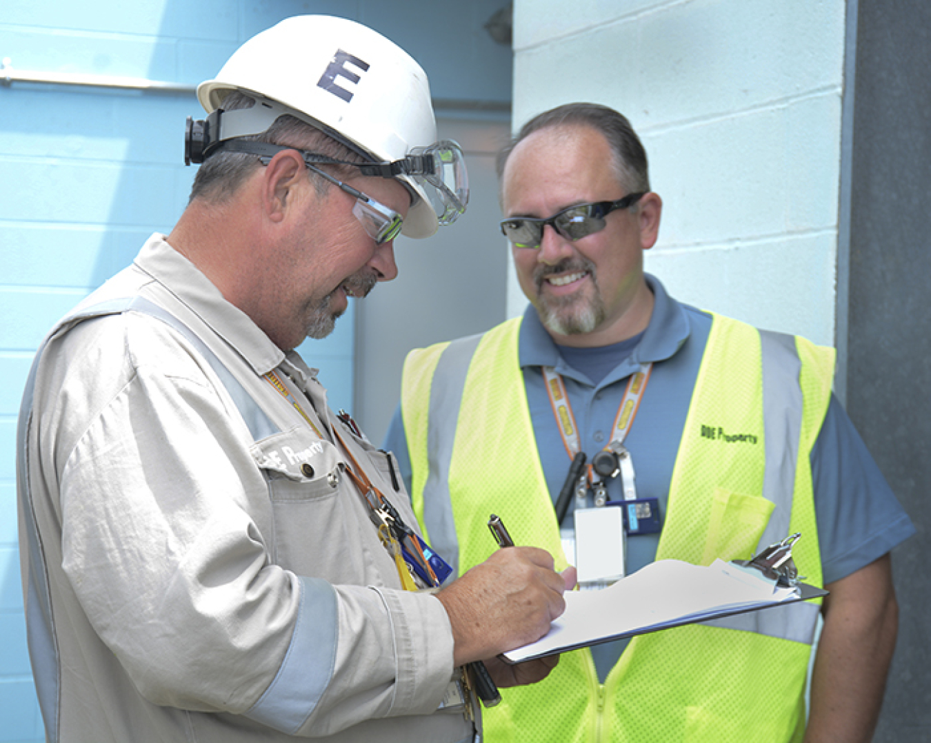Fluor-BWXT Facility Manager Doug Davis (left) and employee Carl Faub complete paperwork to approve the cylinder for transport.