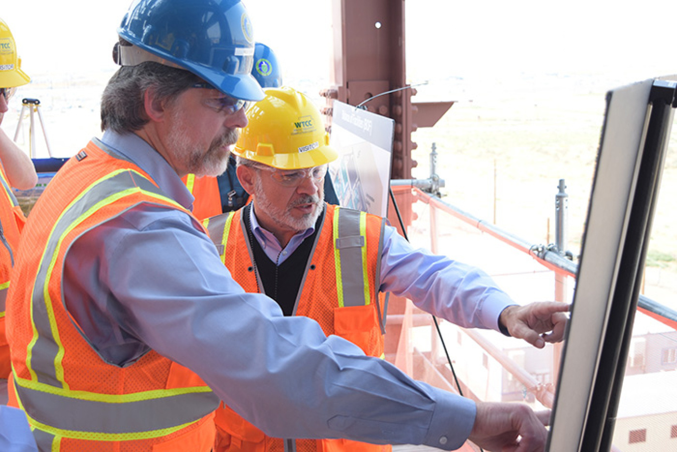 Atop the WTP Pretreatment Facility, Deputy Energy Secretary Dan Brouillette, right, and WTP Assistant Manager Bill Hamel discuss the Direct Feed Low-Activity Waste process to be used to begin vitrifying tank waste as early as 2022.