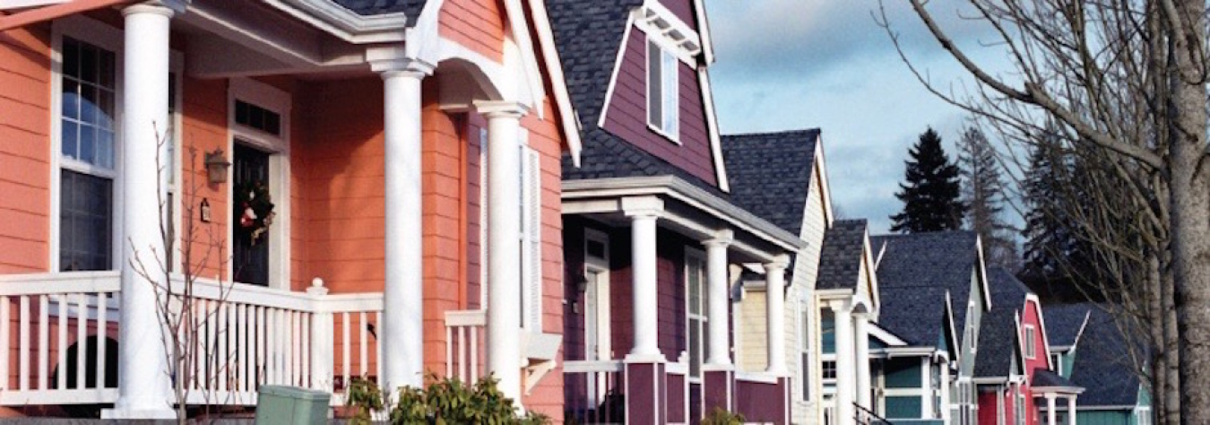 Photo of a row of houses on a street.